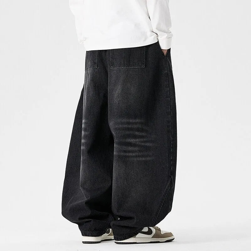 Men's plus-size baggy jeans in light blue denim with straight legs and low waist.