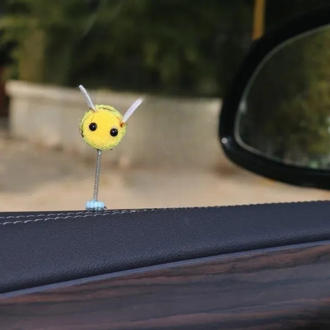Cartoon bee car decoration ornament with furry ball material measuring 3x3cm