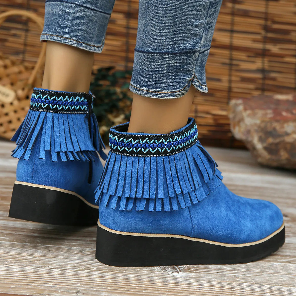 Womens dark brown suede wedge ankle boots with side zip and tassel detail on a thick rubber sole.