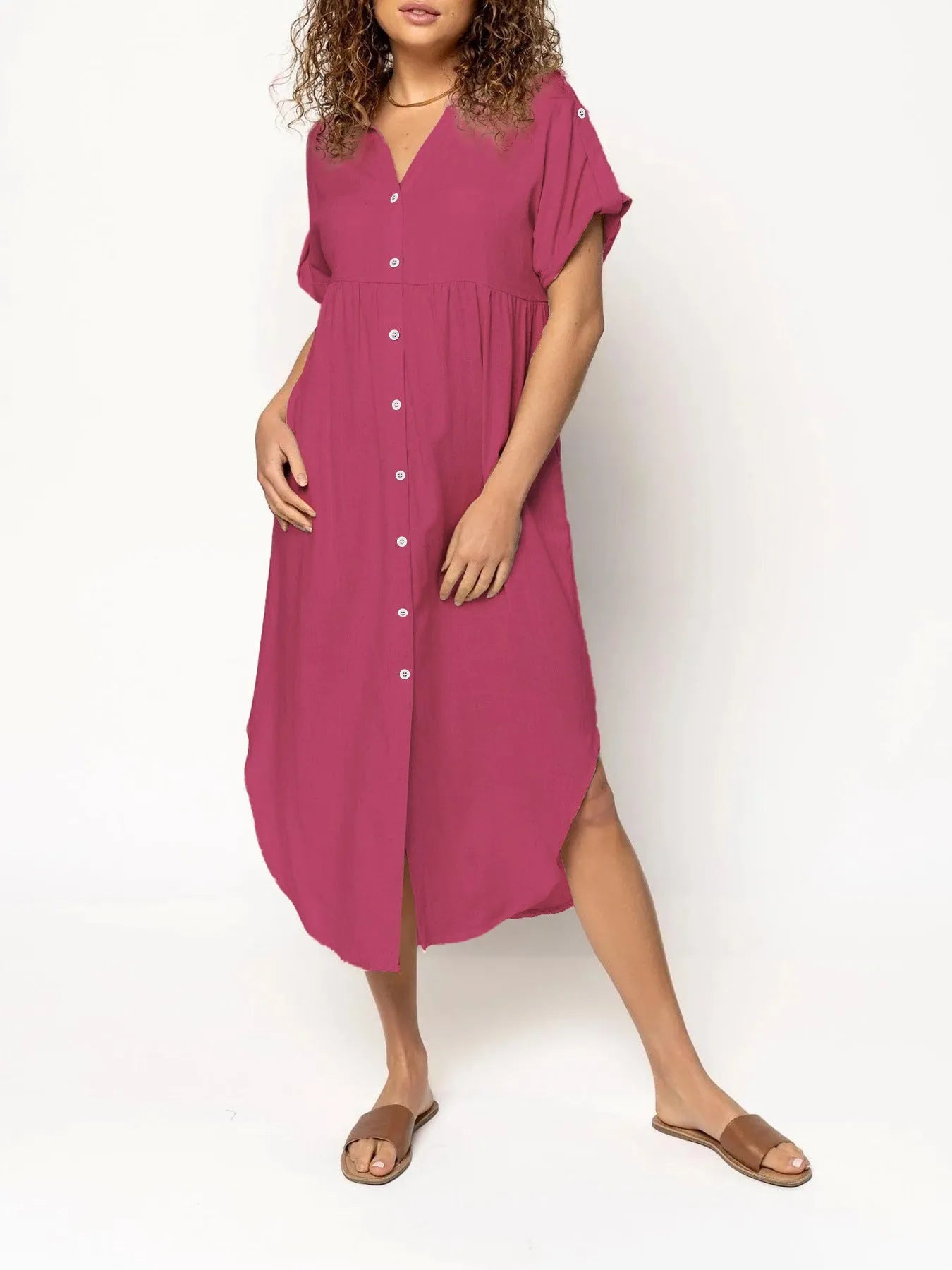 A loose-fitting, solid colour mid-length casual dress with a button-down front and regular sleeves.