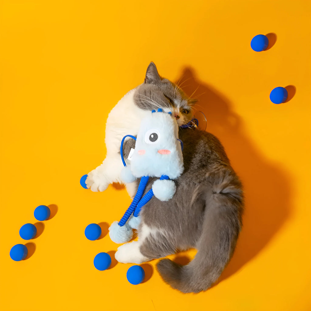 Blue telescopic elastic cat toy with plush ring and mint bell attachment on elastic rope