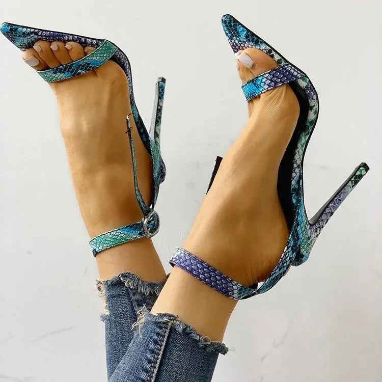 Blue serpentine style women's high heels with buckle fastening and hollow out detail