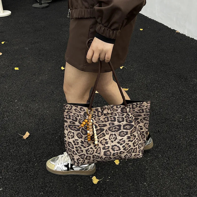 Leopard print polyester hand-held tote bag with double shoulder straps on a white background
