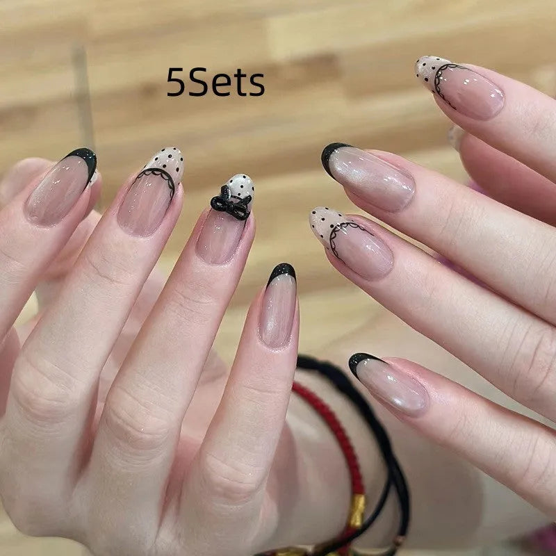 False nails sets for girls showing floral and glitter designs on short oval and stiletto nail shapes