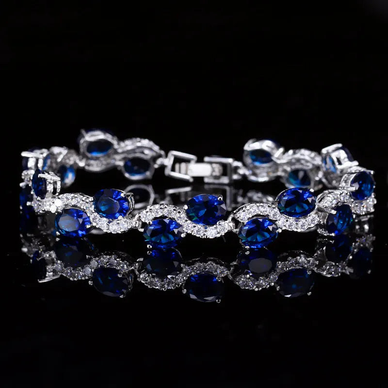 Copper-plated gold bracelet with zircon stones showing 18.4cm length and geometry design