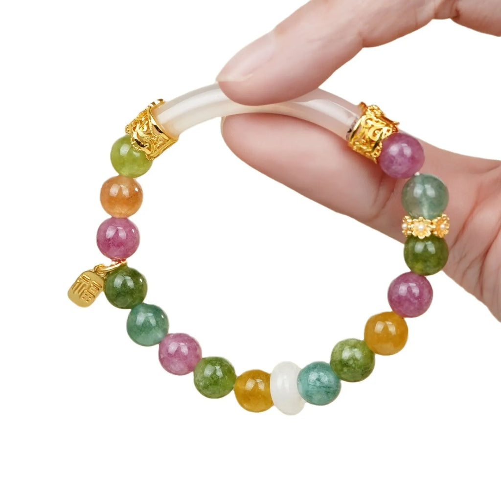 Rainbow-coloured women's half bracelet made from natural tourmaline with a pith centrepiece.
