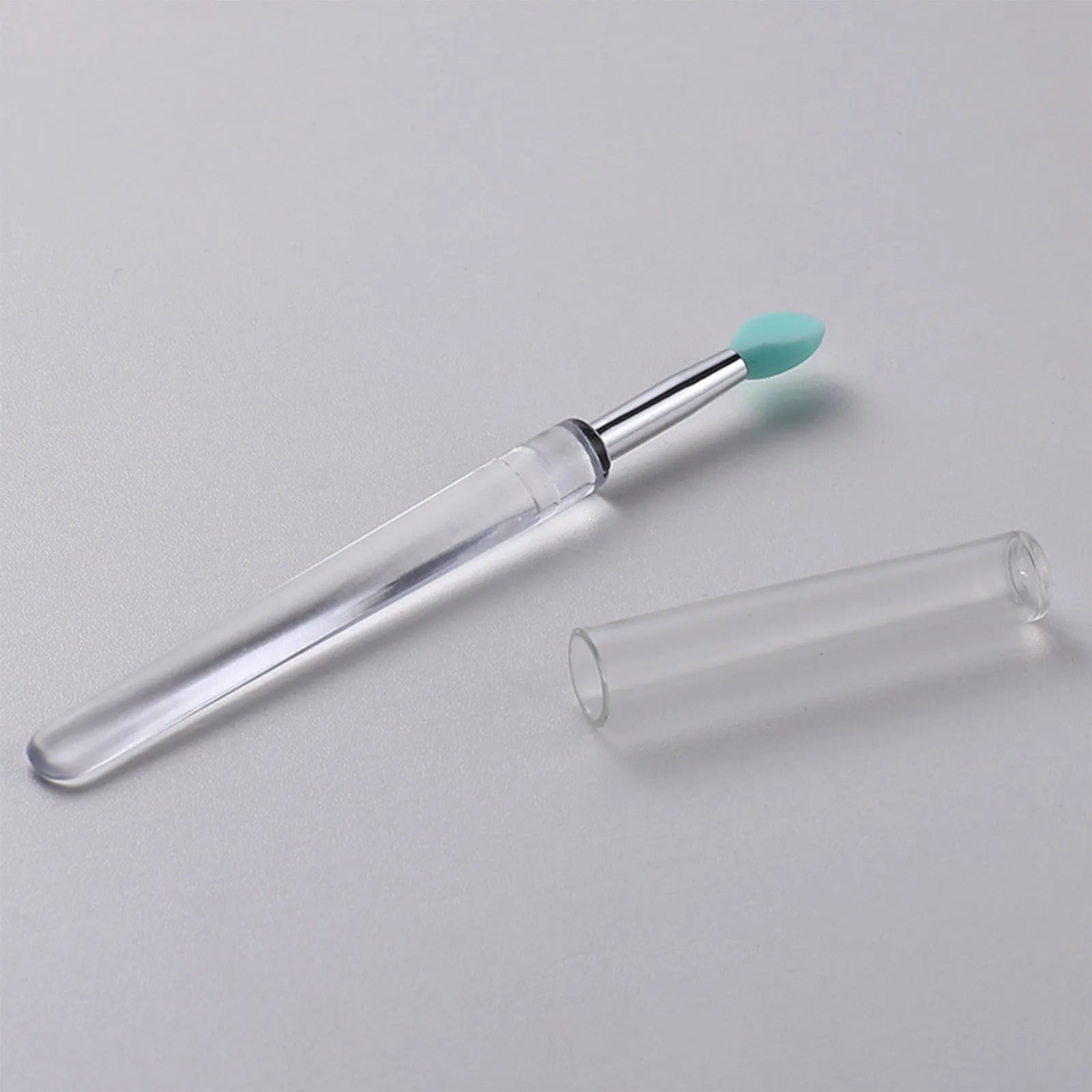 Silicone lip brush with protective cap for hygienic lip product application