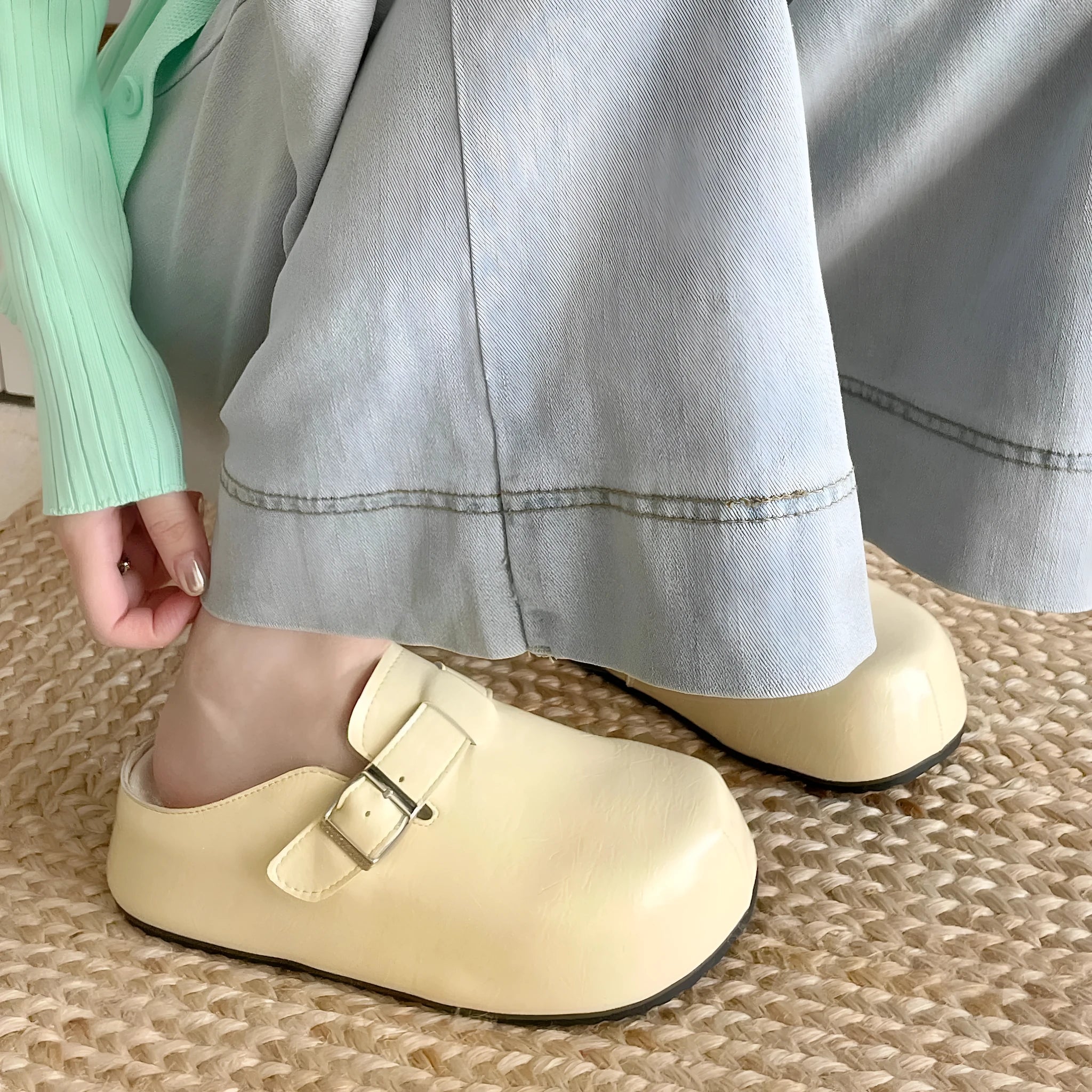 Flat buckle casual sneakers in yellow, black, silver, and creamy-white colours with rounded toe shape