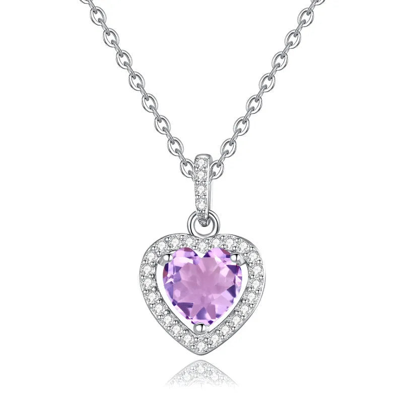 Heart-shaped sterling silver pendant necklace with a natural gemstone on an adjustable chain.