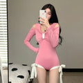 Women's long-sleeved one-piece swimsuit in polyester fabric available in pink and black colours