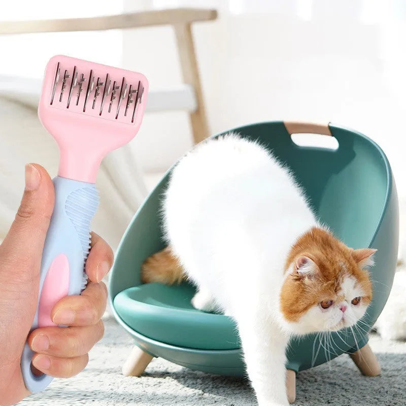 Pink stainless steel pet comb with comb teeth and an integrated knot-cutting knife blade.