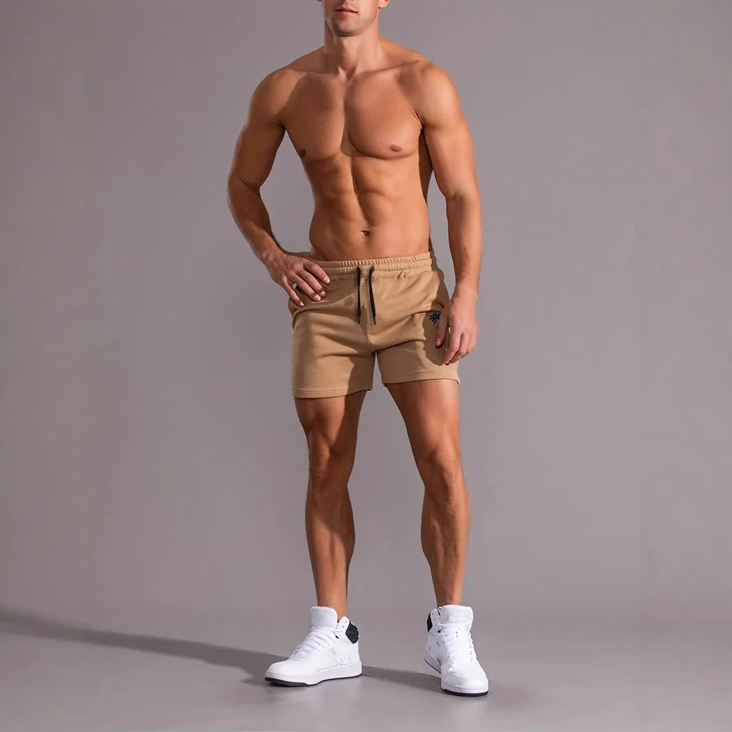 Men's khaki coconut print sports shorts with elastic waistband and straight leg cut