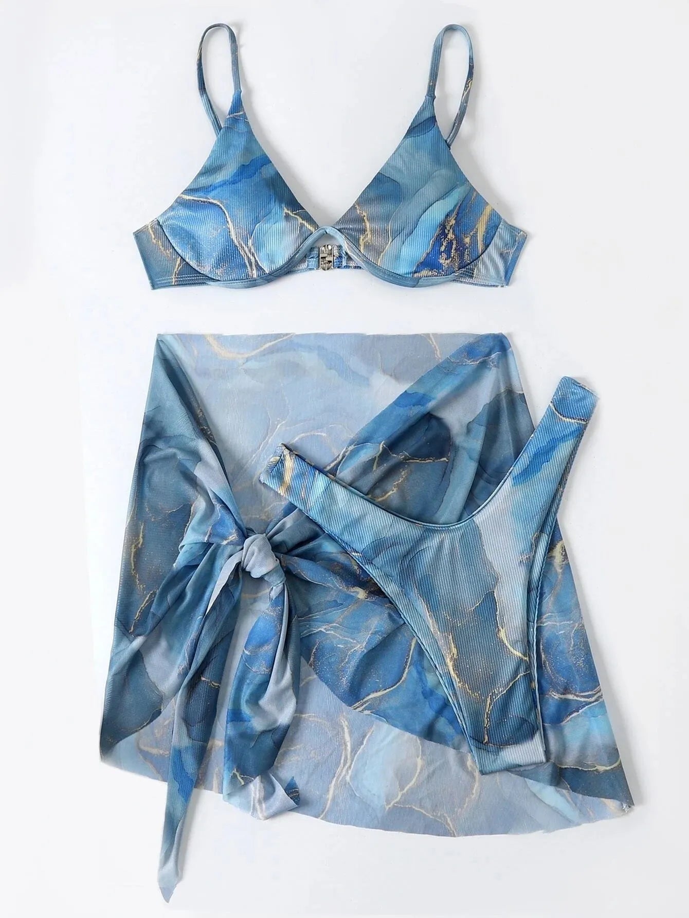 Women's marble print bikini set with triangle bra, briefs, and matching skirt in blue.
