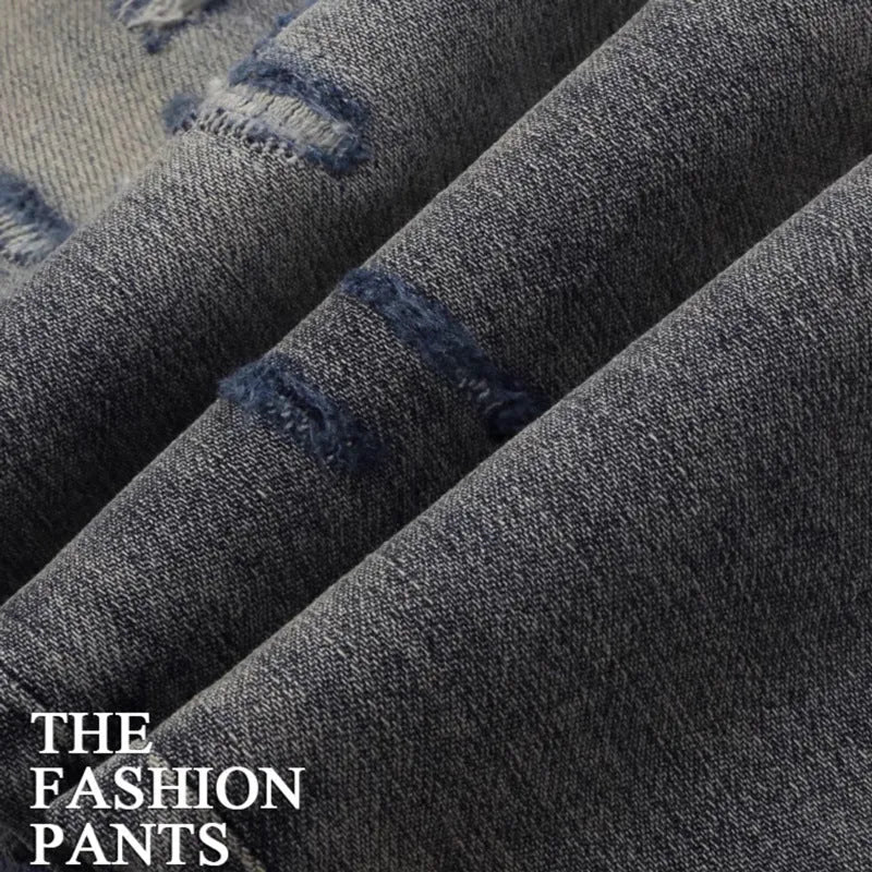 Slim fit jeans with washed-out old colour, distressed holes, and embroidered patches on cotton fabric