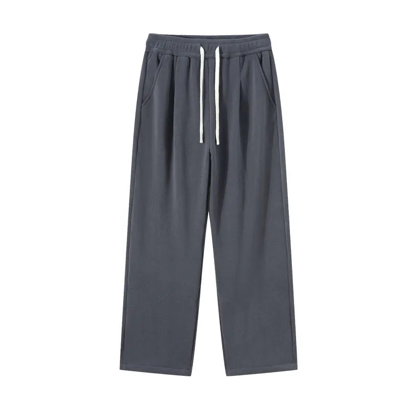 Men's thick apricot coloured fleece-lined loose fit casual sports trousers on a hanger.