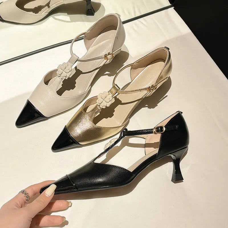Women's black stiletto heel pointed toe shoe with floral buckle on sheepskin leather upper.