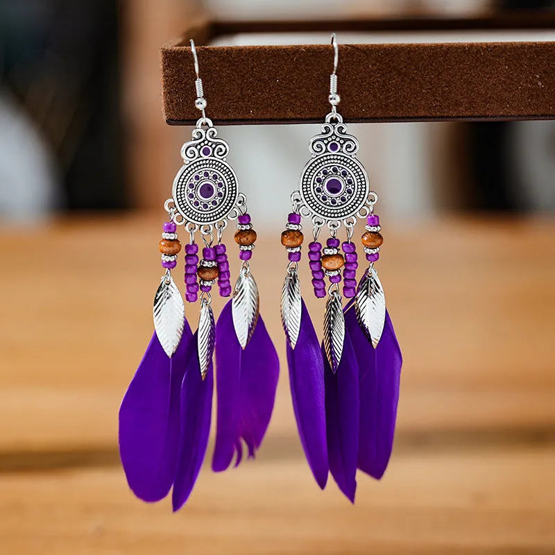 A pair of bohemian-style round drop earrings with a feather leaf pattern, shown in one of thirteen available colours.