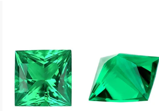 Loose cultivated emerald gemstone in Columbia green colour showing round and fancy cut shapes on a white background.