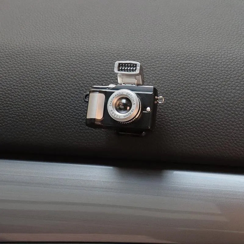 Set of four retro camera dot design plastic adhesive hooks for car dashboard organisation.