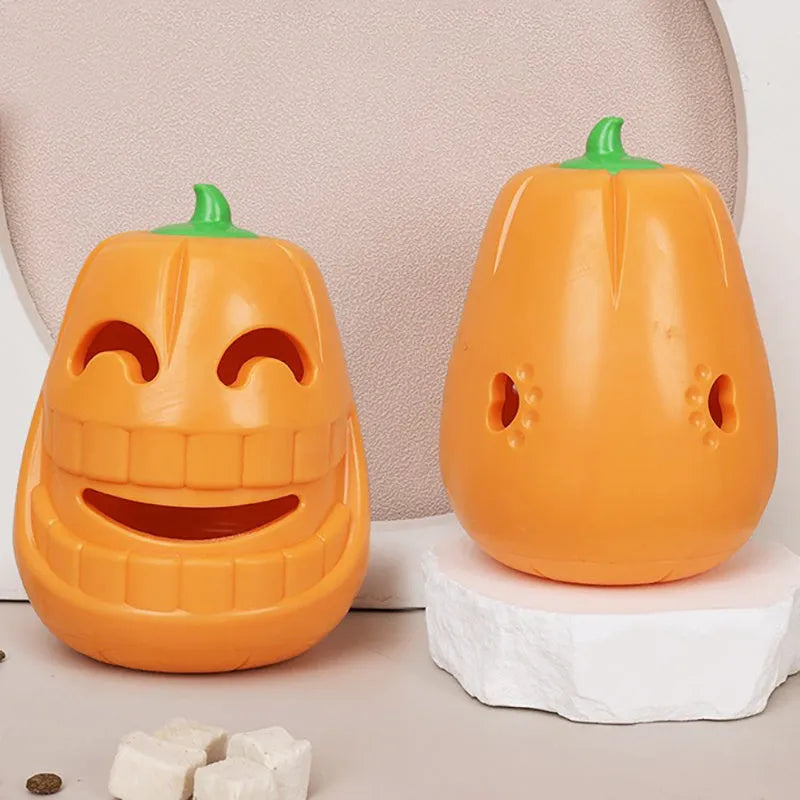 Orange Halloween pumpkin-shaped rubber dog chew toy with a treat-dispensing funnel hole.