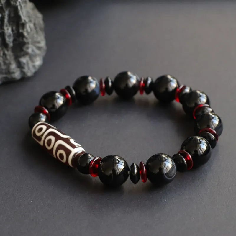 Black agate Dzi bead bracelet with geometric 11mm beads on wrist