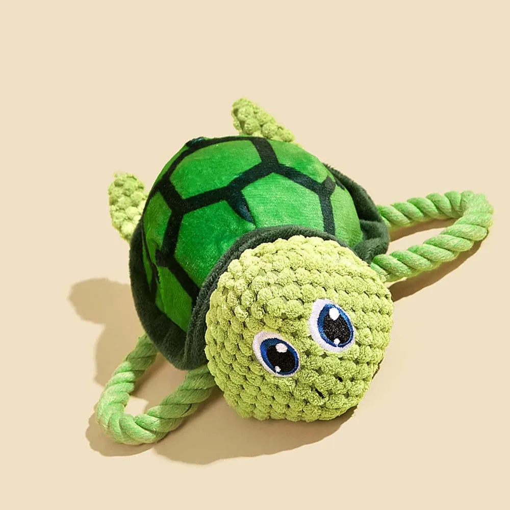 Grey, green, and orange turtle-shaped plush dog chew toy with knotted texture
