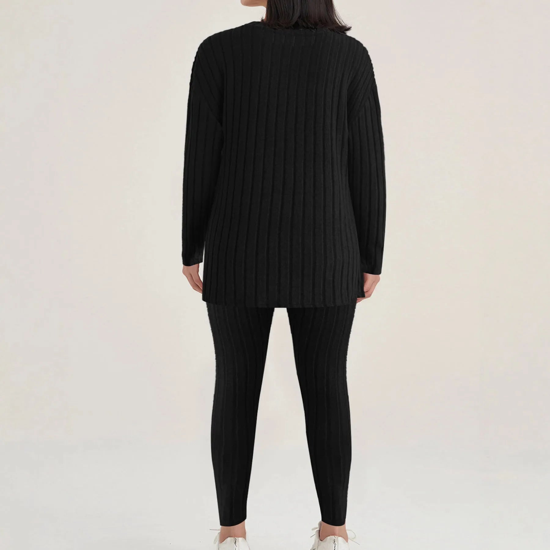 Women's black two-piece lounge set with a sunken stripe pattern on the top and matching trousers.