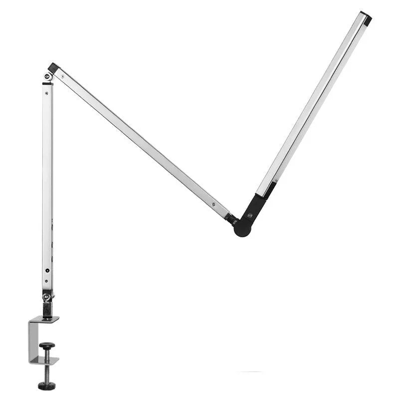 Black adjustable clip-on desk lamp with flexible arm and remote control on a wooden desk