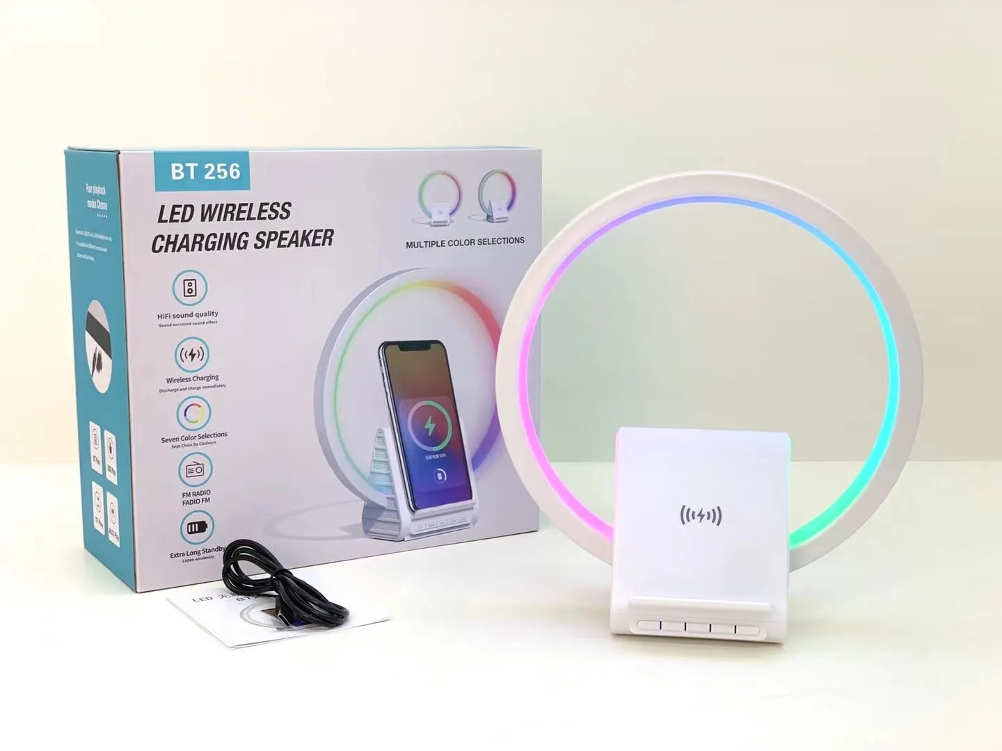 White Bluetooth speaker with wireless charging surface and ambient lighting