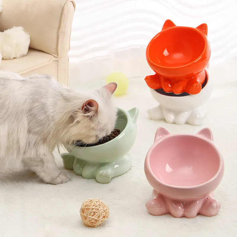 Ceramic cat bowl with neck guard in black and white and pink and blue colour options on a white background