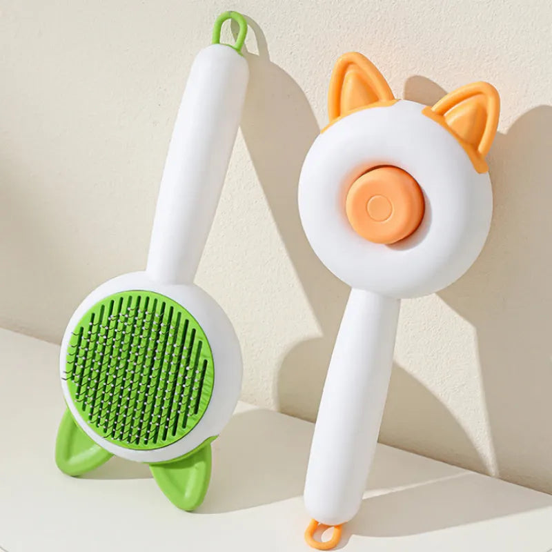 Self-cleaning cat grooming comb with stainless steel bristles in greenish white and orange white colour options
