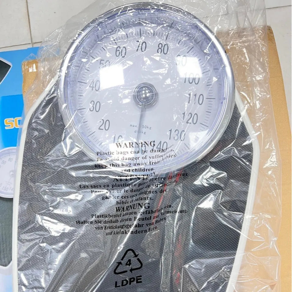 Black mechanical body weight scale with large dial measuring 47x35x11cm