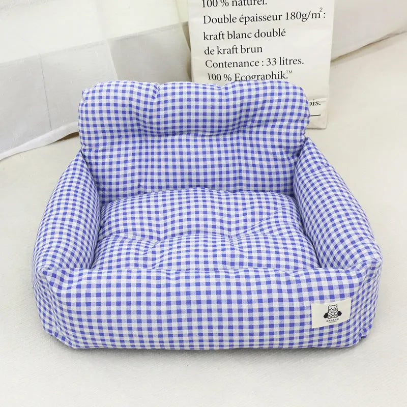 Grey and blue plaid cloth dog travel nest for car use, shown in two sizes.
