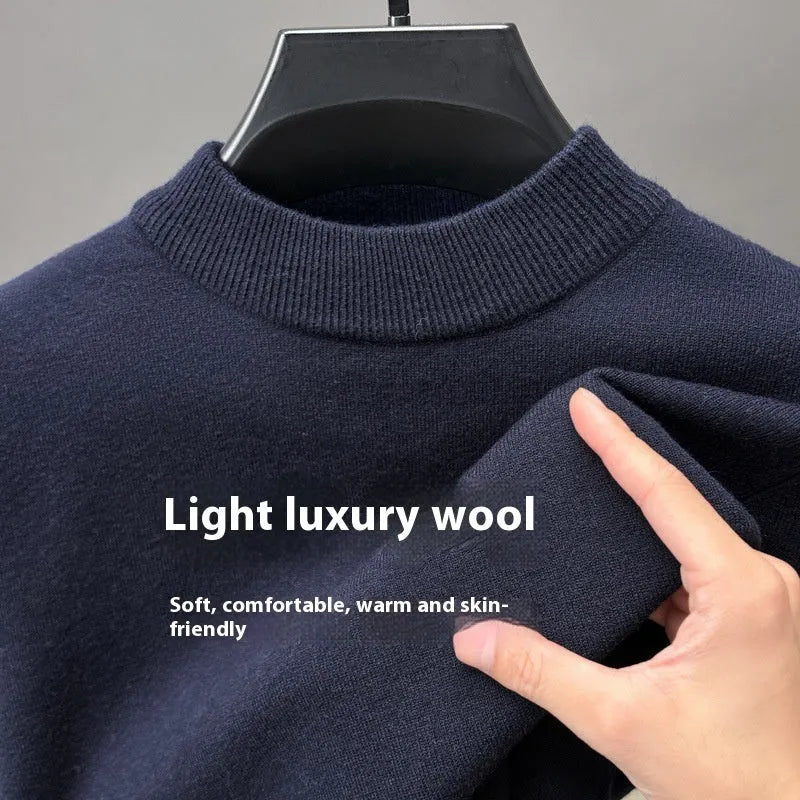 Man wearing a solid colour half turtleneck long sleeve jumper in a casual setting.