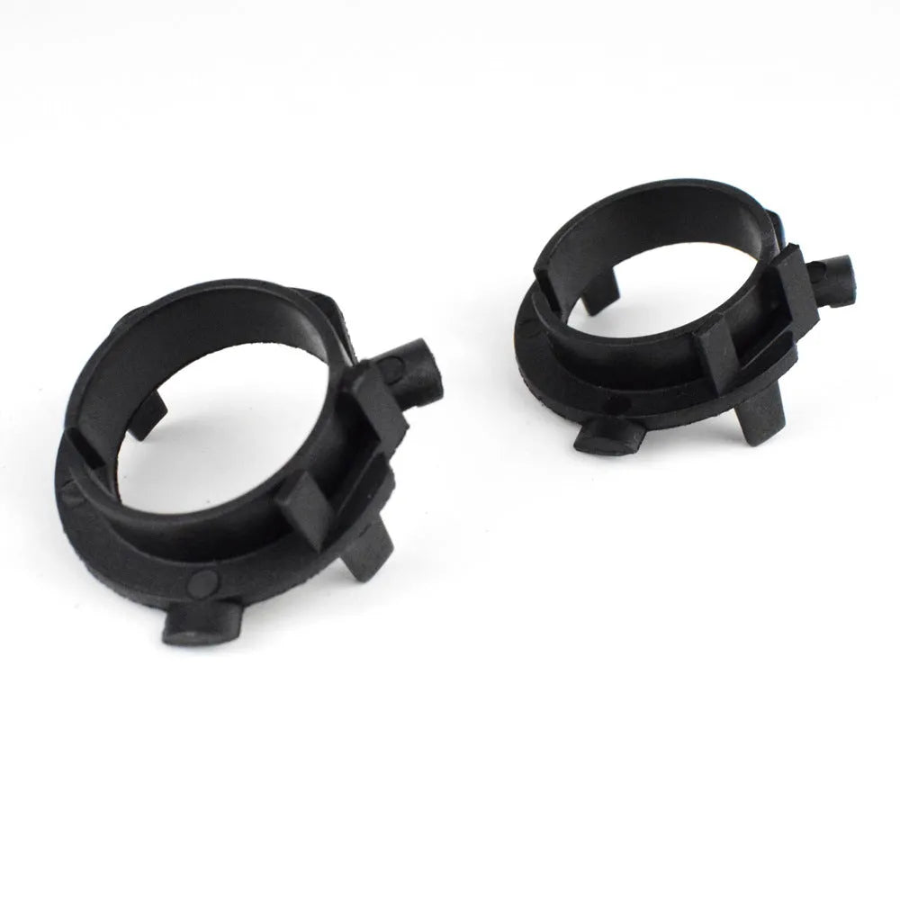 Black ABS plastic LED headlight shaped card holder for car dashboard.