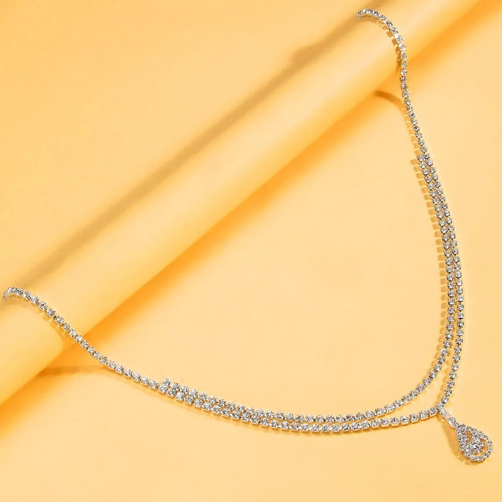 Gold or silver rhinestone waist chain with water drop pendant and tassel detail
