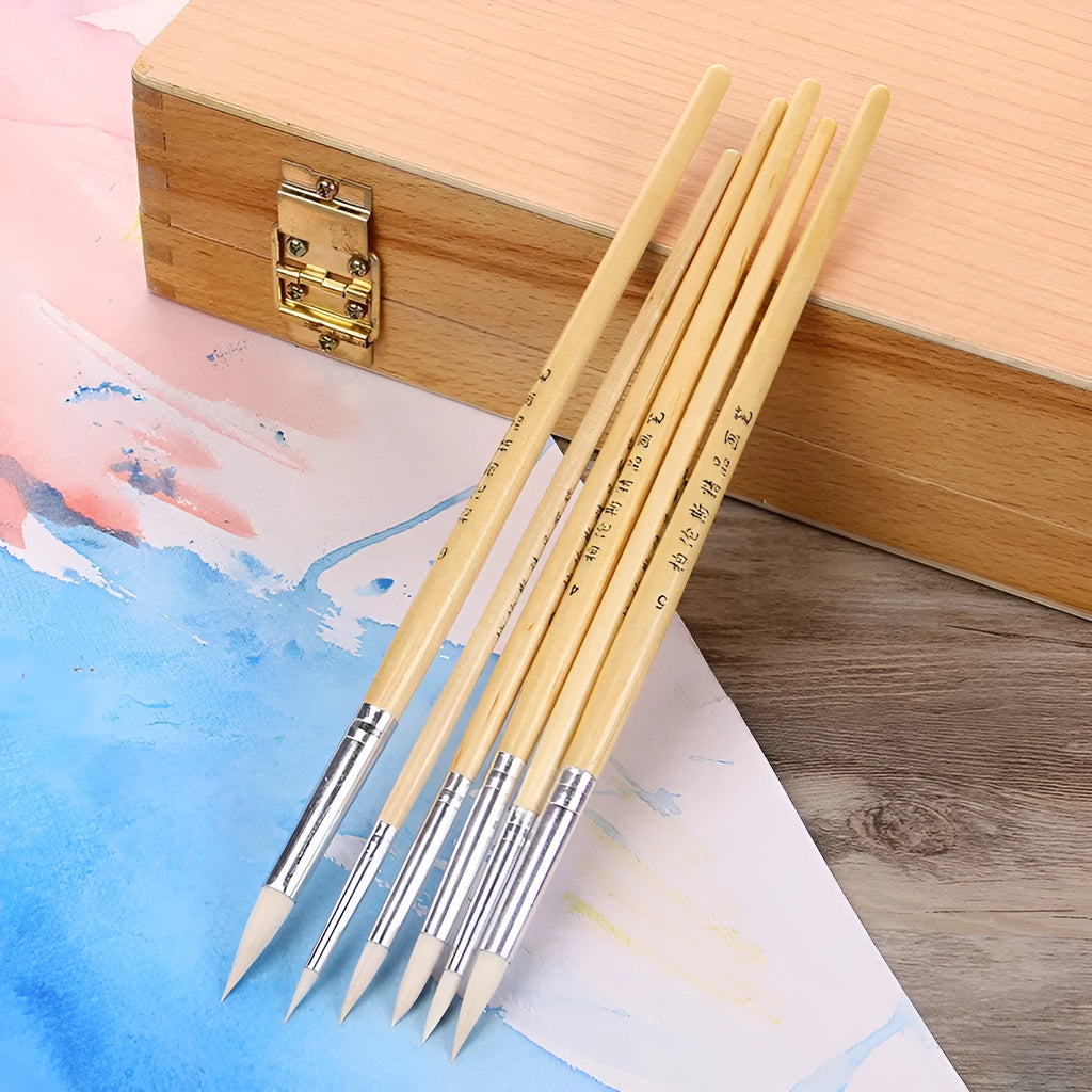 Six wooden-handled art brushes with pointed wool tips arranged together