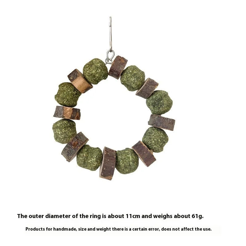 Hamster chew toy with a straw ball ring and natural applewood molar rod on a white background.