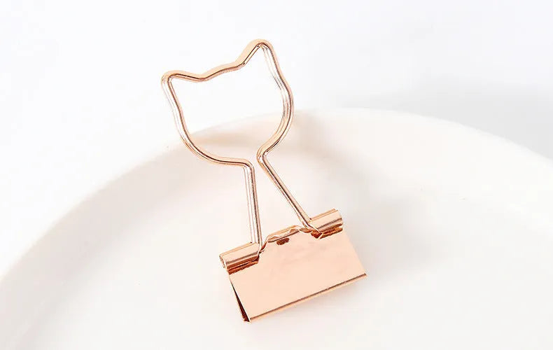 Gold-plated long-tail metal clip with a choice of bow, cactus, cat, flamingo, love, or cloud decorative design.