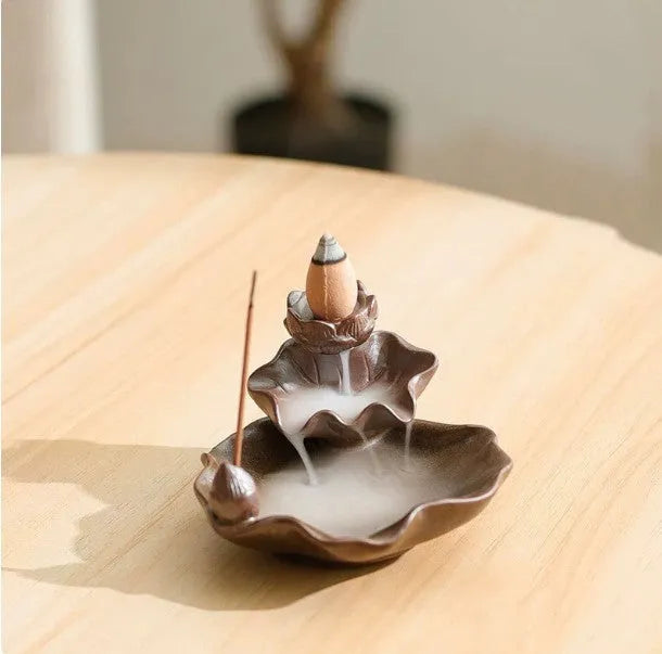 Ceramic reverse flow incense burner in purple clay with crystal glaze featuring lotus or plum blossom design