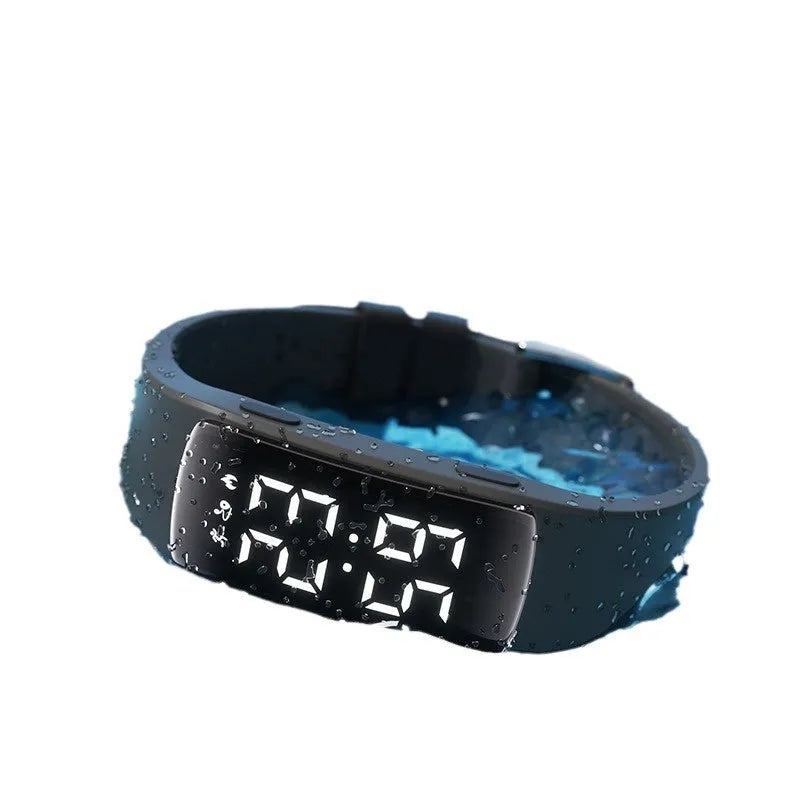 Waterproof vibration alarm clock watch with black silicone strap and LED display showing time