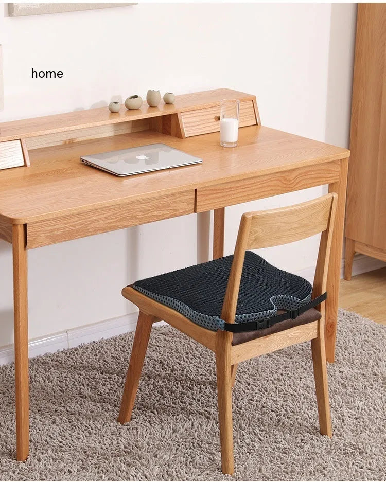 Memory foam car and office chair cushion with an attached fixed strap in a solid colour.