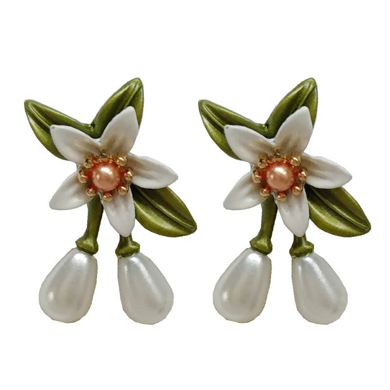 Women's alloy flower earrings set showing sterling silver needle flower studs and matching flower ear clip pair