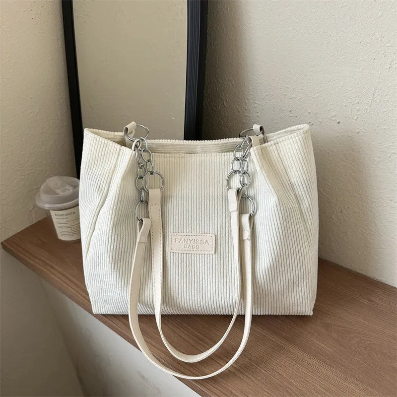 Corduroy one-shoulder tote handbag in a horizontal square shape, shown in brown colour.