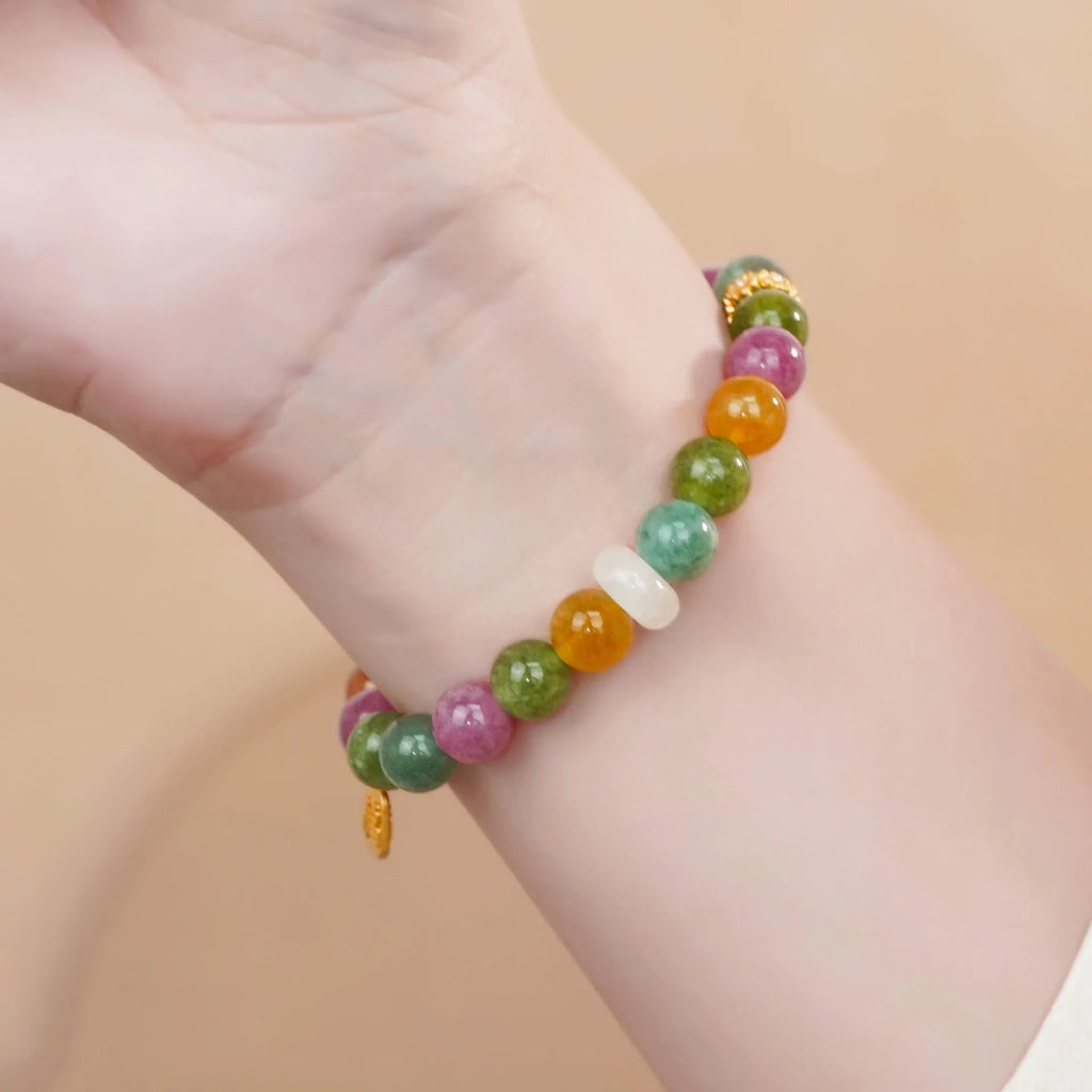 Rainbow-coloured women's half bracelet made from natural tourmaline with a pith centrepiece.