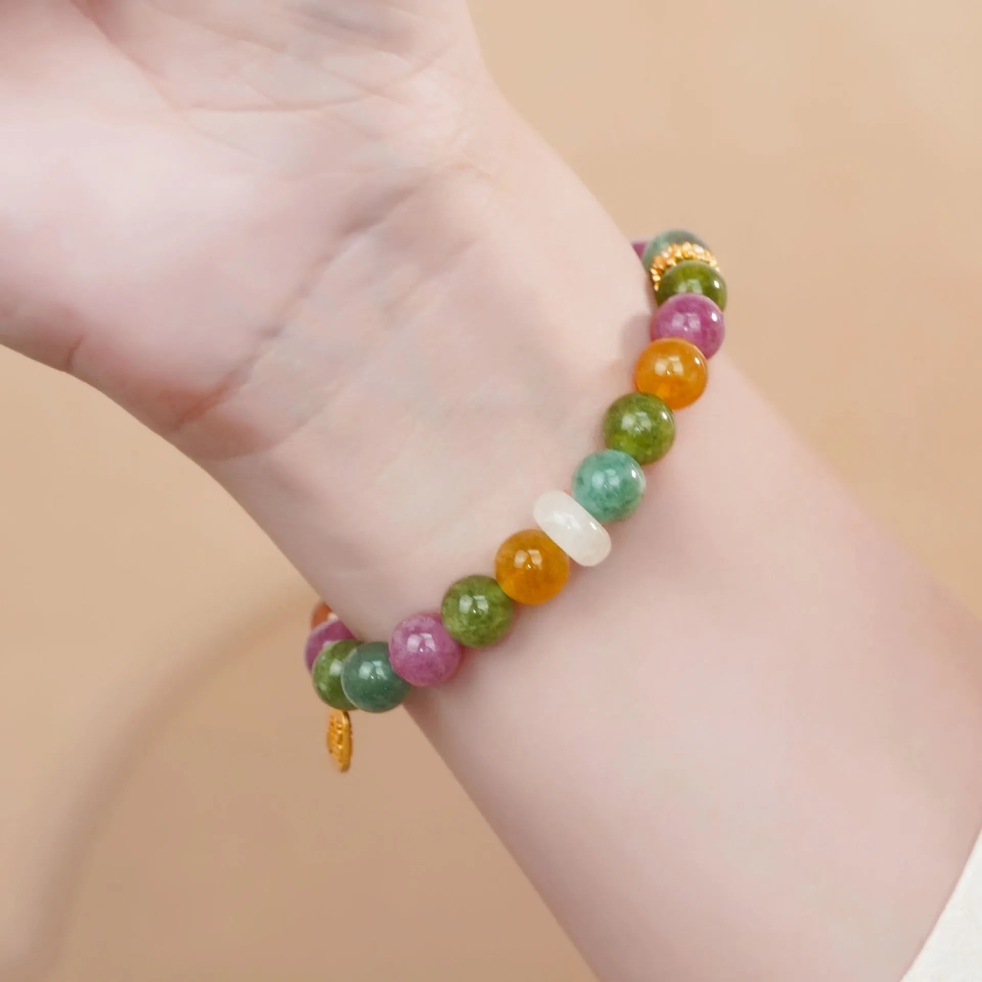 Rainbow-coloured women's half bracelet made from natural tourmaline with a pith centrepiece.
