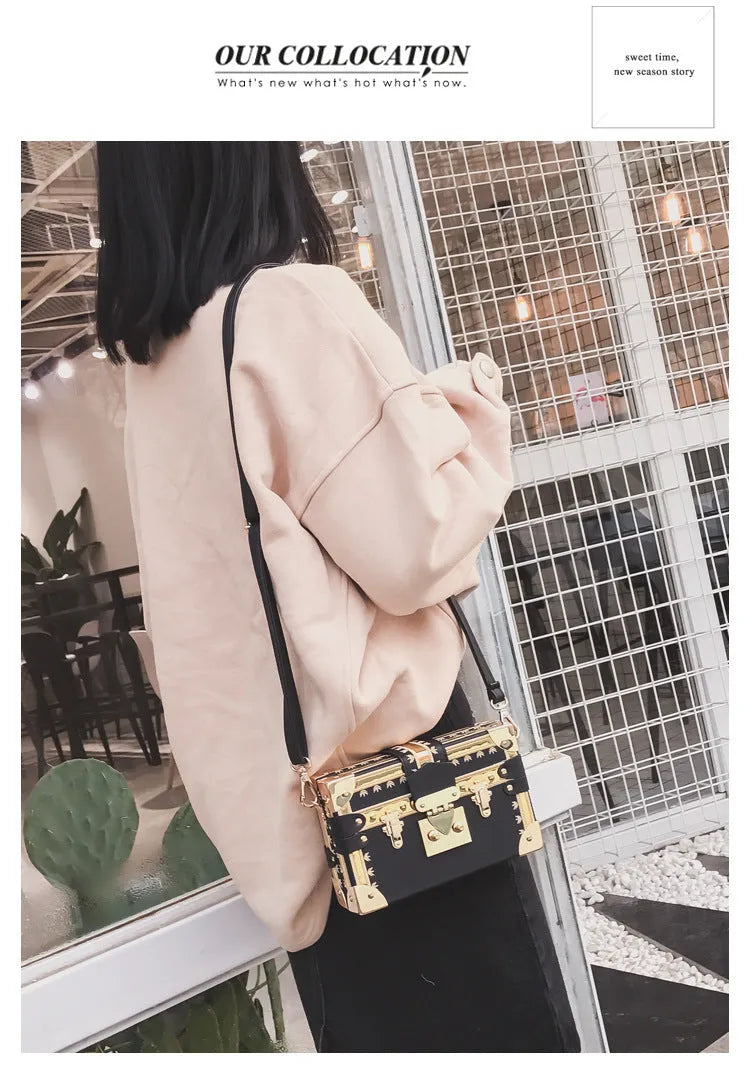 Hard black PU women's shoulder bag with flap closure and single adjustable cross-body strap.