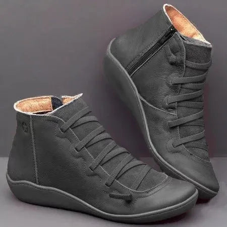 Women's flat wedge heel ankle booties in various colours including leopard print, with round toe and rubber sole.