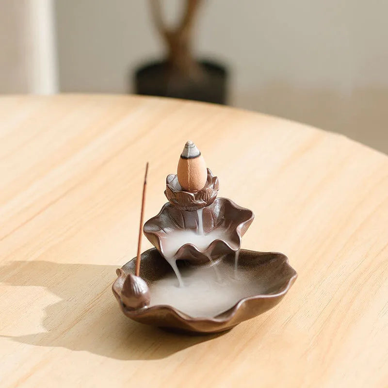 Ceramic reverse flow incense burner in purple clay with crystal glaze featuring lotus or plum blossom design