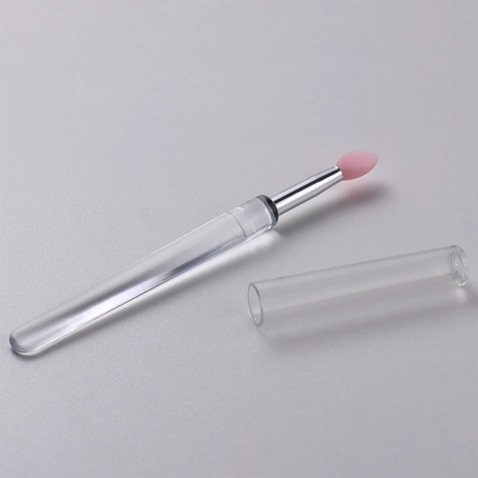Silicone lip brush with protective cap for hygienic lip product application